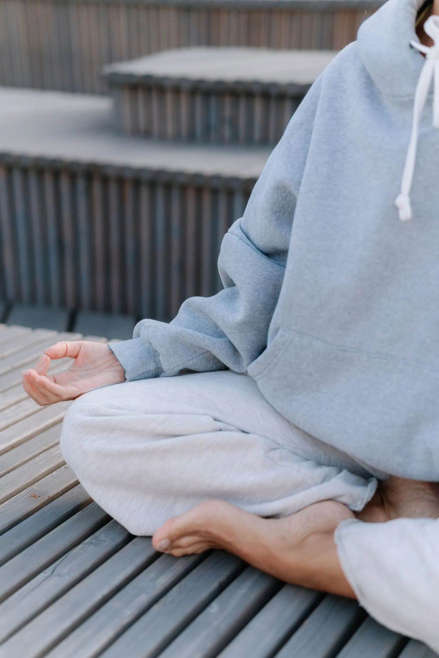 A person sitting calmly in a meditation pose, representing mental wellness